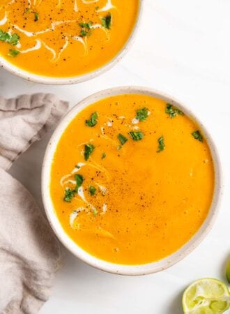 Overhead view of a bowl of butternut squash soup topped with a sprinkle of cilantro.