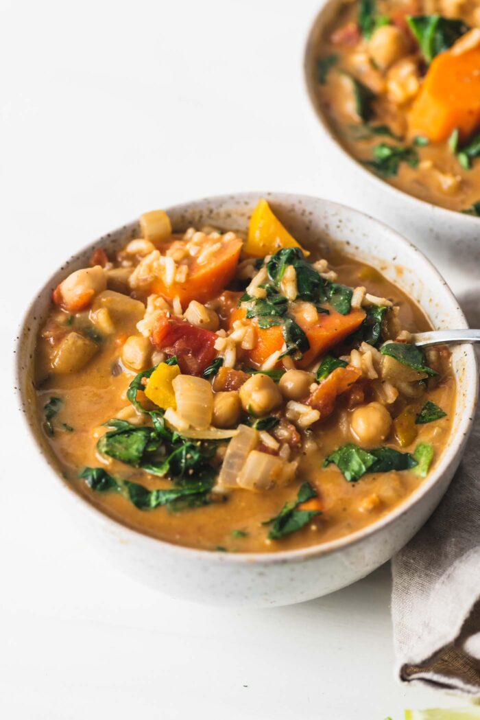 Bowl of hearty stew with spinach, chickpeas and rice.
