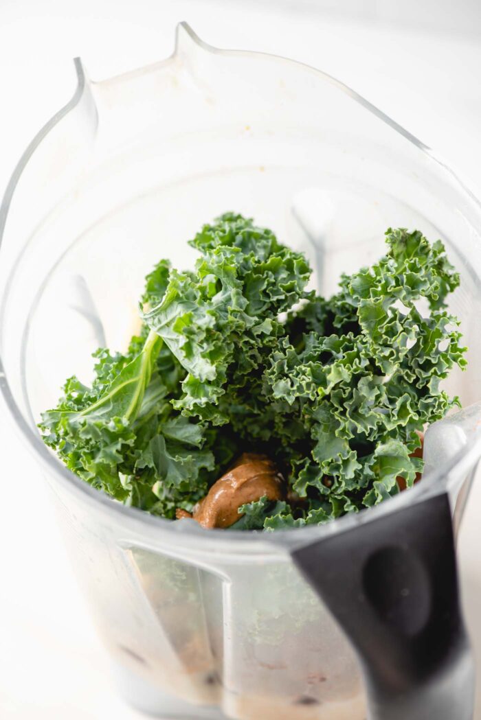Kale and almond butter in a blender.