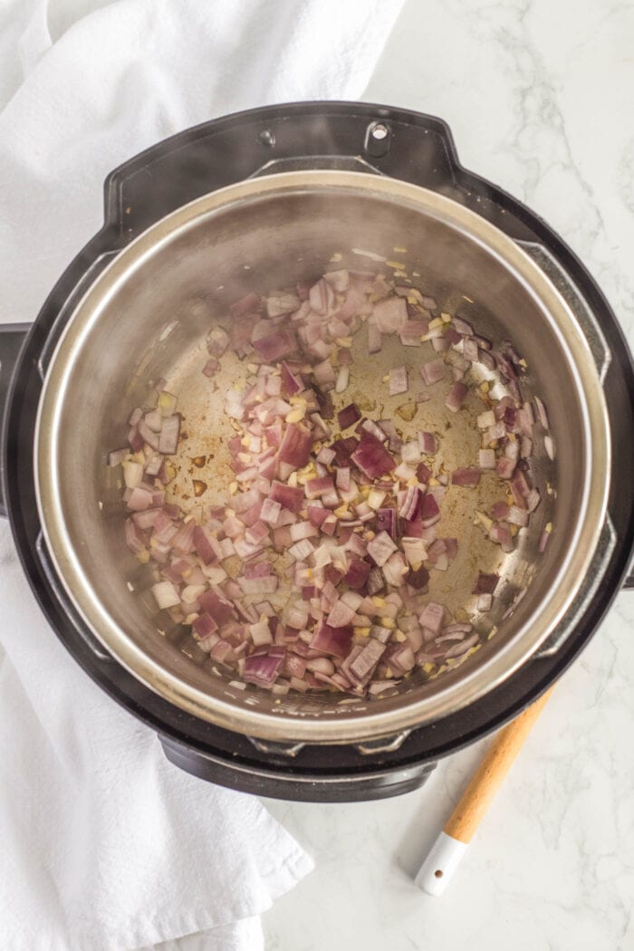Onion and garlic cooking in an Instant Pot.
