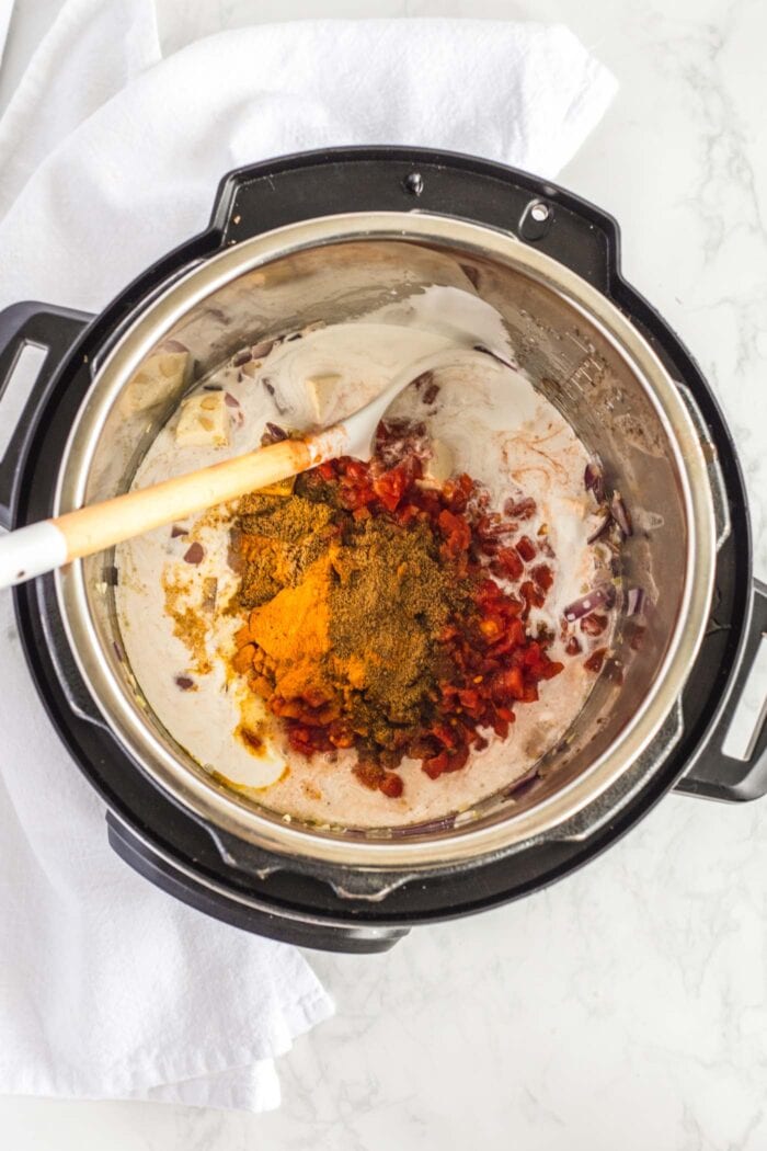 Coconut milk, tomato and spices in an Instant Pot.