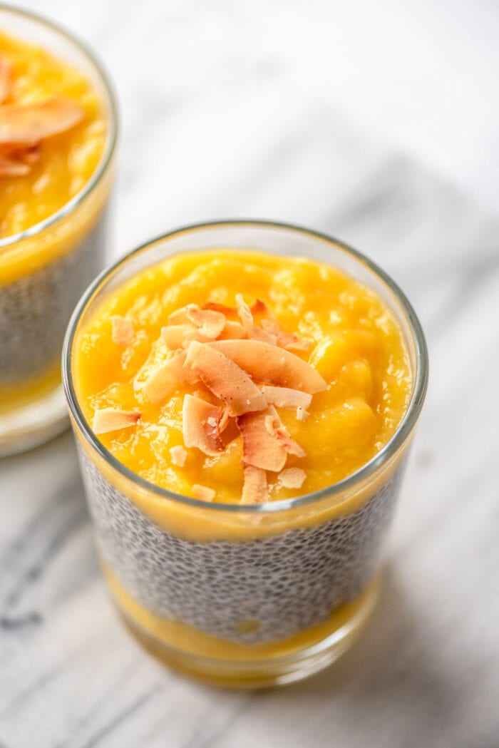 Overhead view of pureed mango layered over chia seed pudding in a glass jar.