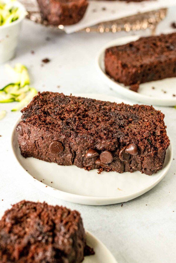 Thick slice of chocolate chip zucchini bread on a plate.