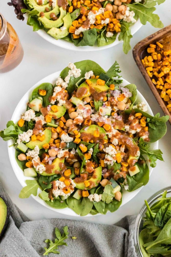 Overhead view of a salad with avocado, corn, chickpeas and feta.