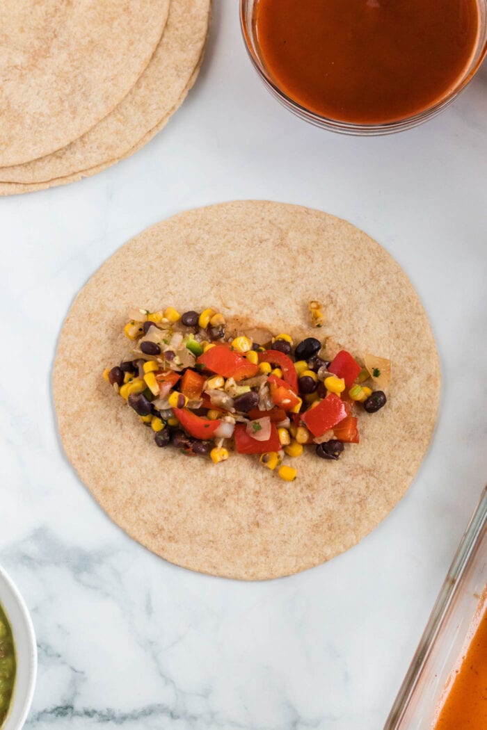 Black beans, bell peppers and corn on a tortilla.