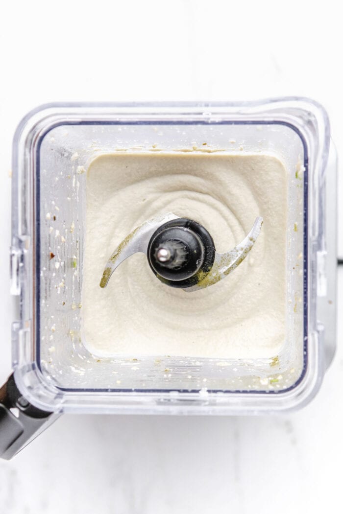 A thick, creamy mixture blended in a blender container.