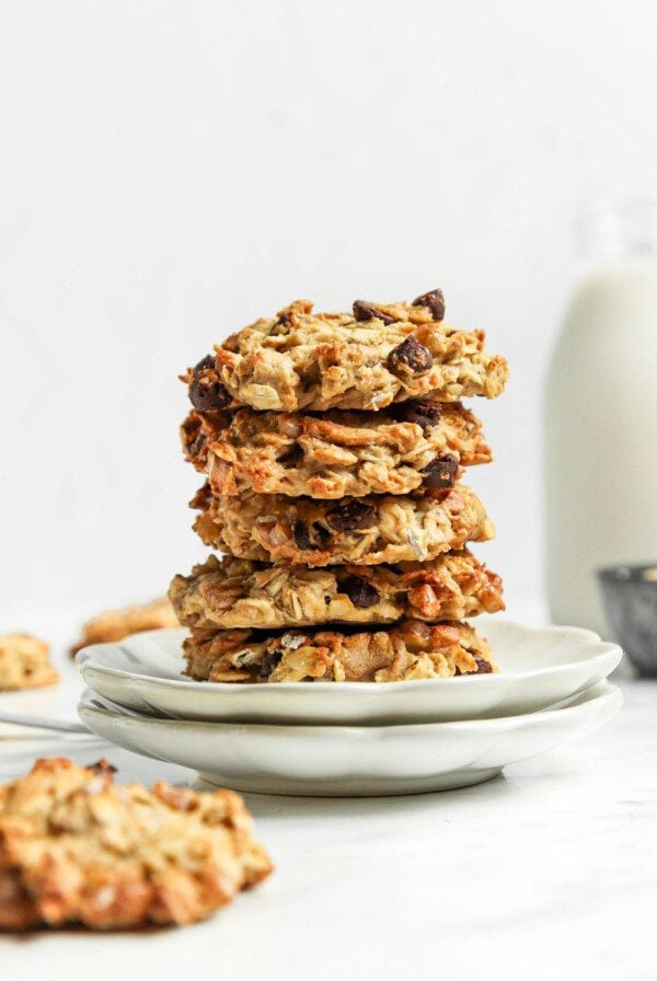 Stack of 3 oatmeal chocolate chip cookies on a small white plate.