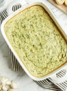 Cooked spinach artichoke dip in a baking dish.
