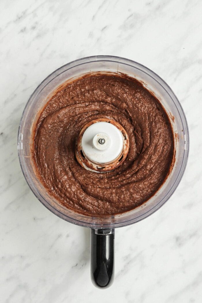 Thick chocolate batter in a food processor.