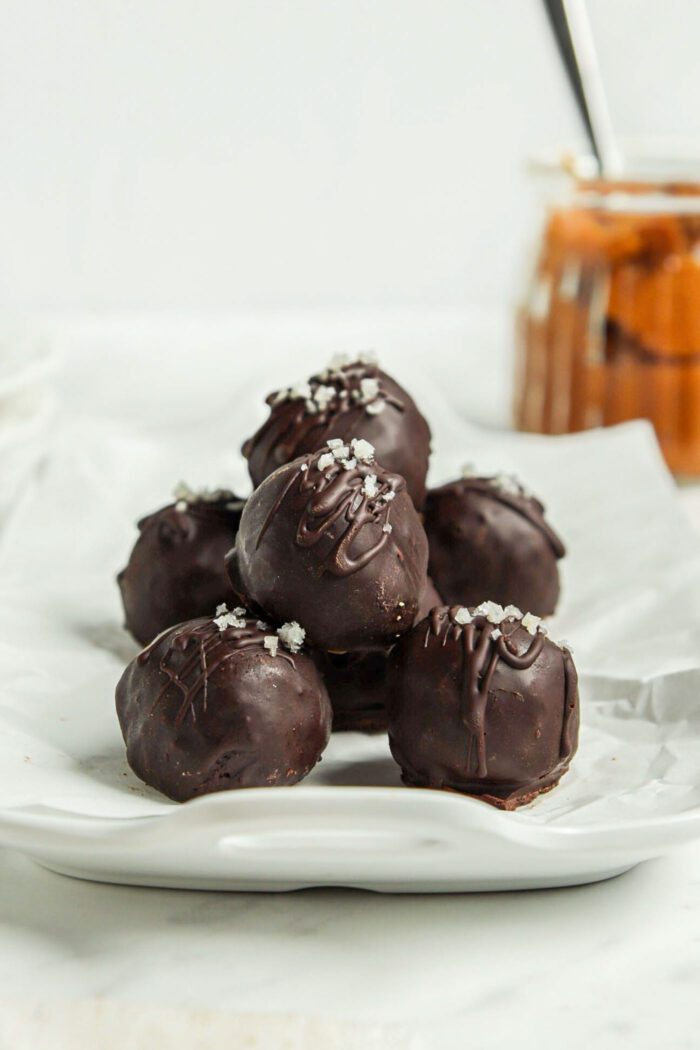 Chocolate truffles on a parchment paper-lined tray.