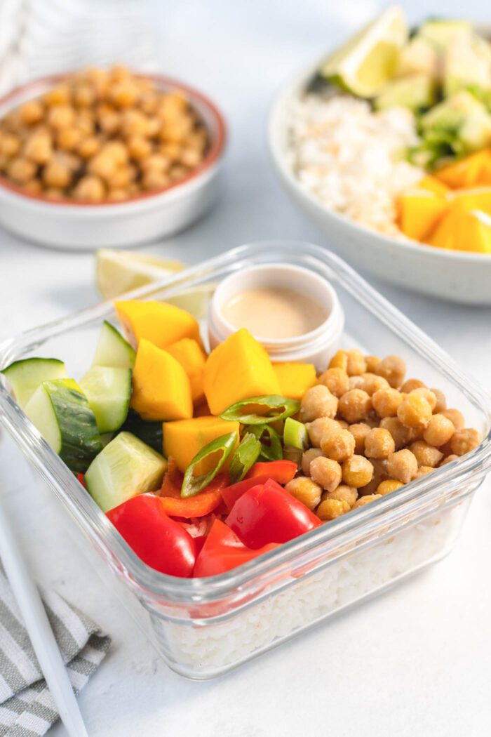 Chickpeas, veggies and rice in a glass food storage container.