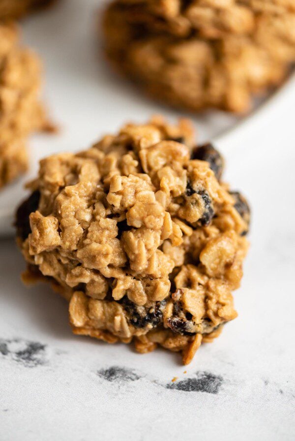 Close up of an oatmeal cookie with cranberries and walnuts in it.