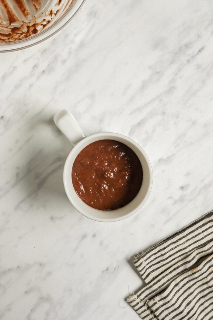 Chocolate cake batter in a mug.