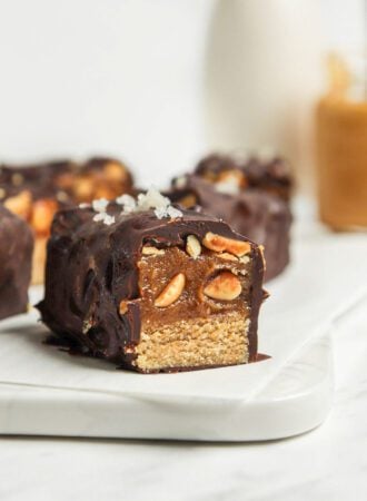 Close up of a homemade snickers bar on a cutting board.