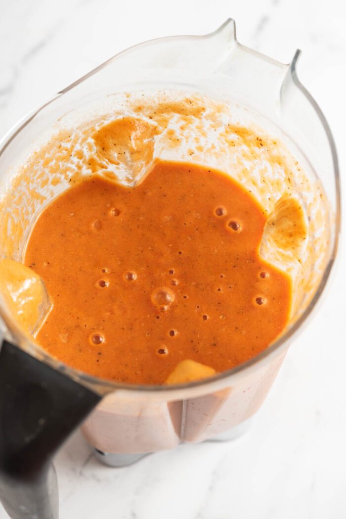 Creamy blended tomato soup in a blender.