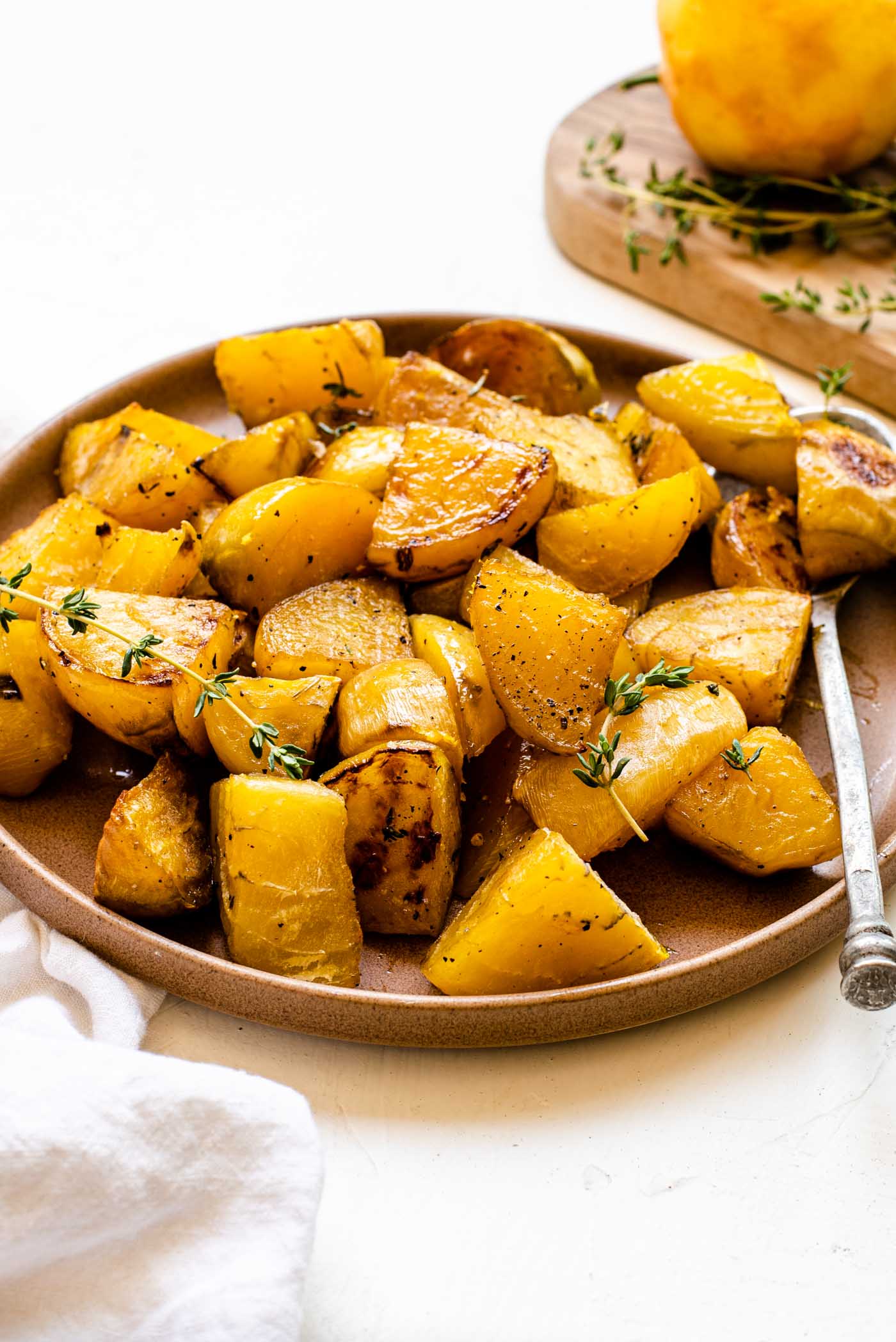 Plate of roasted golden beets with fresh thyme.