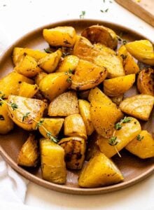 Plate of roasted golden beets with fresh thyme.