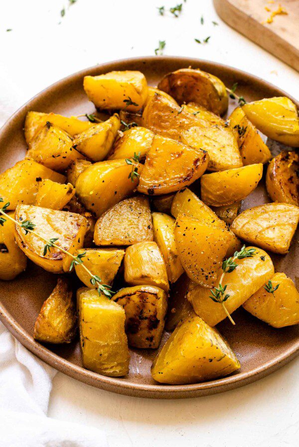 Plate of roasted golden beets with fresh thyme.