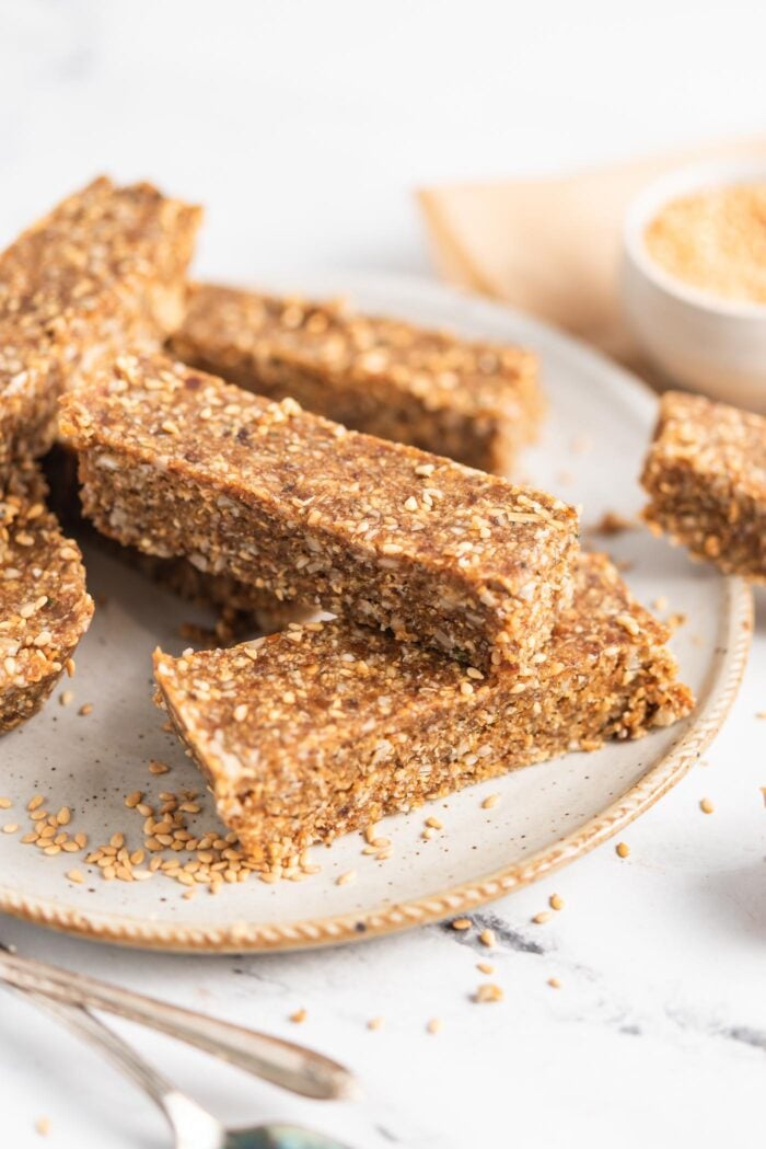 Close up of sesame and sunflower seed energy bars on a plate.