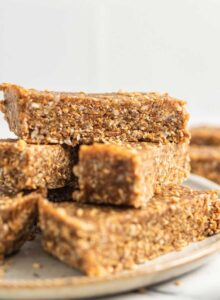 Close up of sesame and sunflower seed energy bars on a plate.