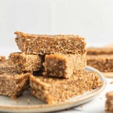 Close up of sesame and sunflower seed energy bars on a plate.