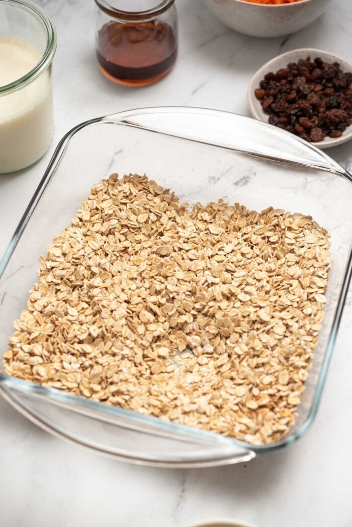 Rolled oats in a square glass baking dish.