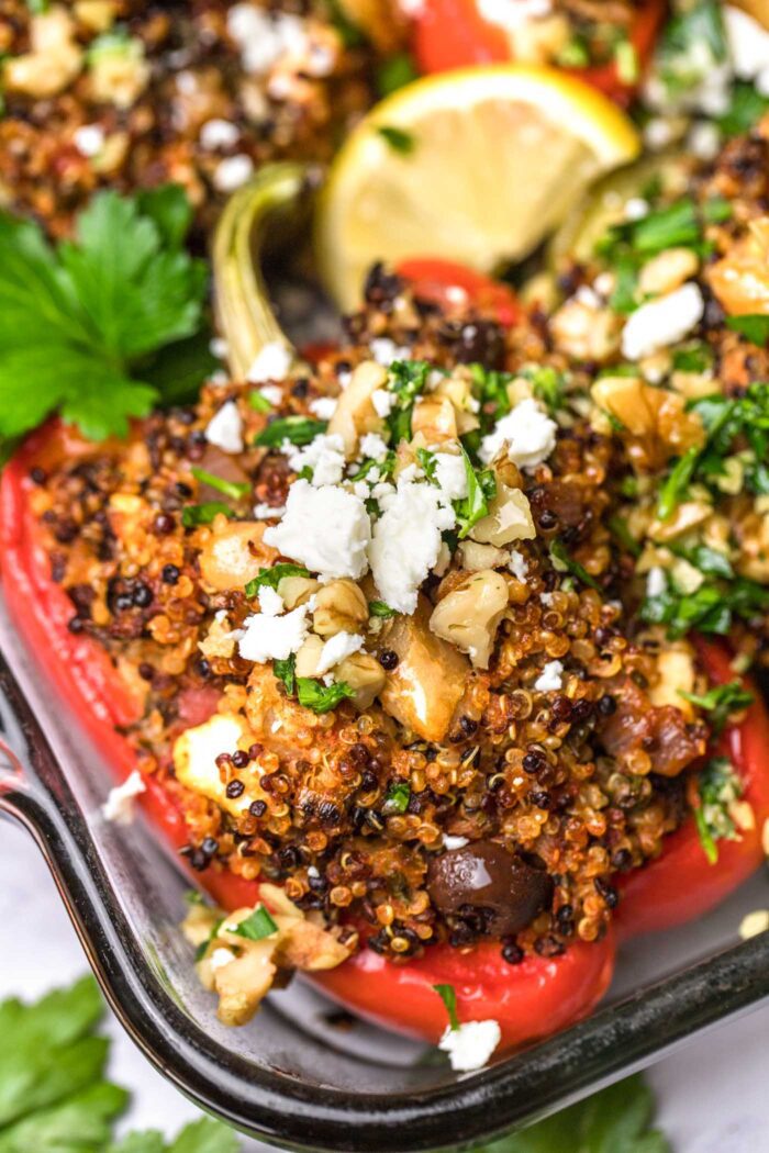 Close up of a quinoa and white bean stuffed bell pepper topped with feta.