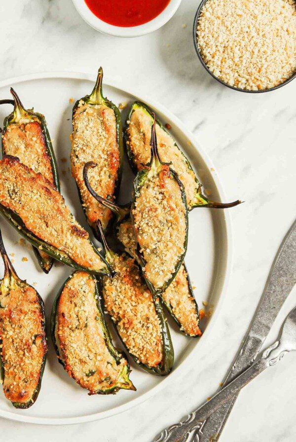 Overhead view of a plate of vegan baked jalapeno poppers.