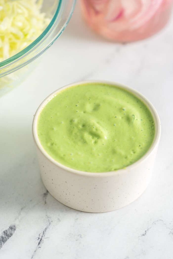 Green sauce in a small round dish.