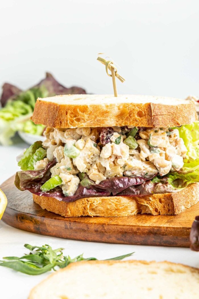 Vegan chicken salad made with tempeh on a sandwich with lettuce.