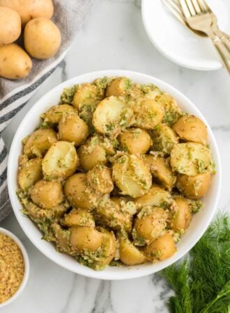 Bowl of tangy dill and dijon potato salad made without mayonnaise.
