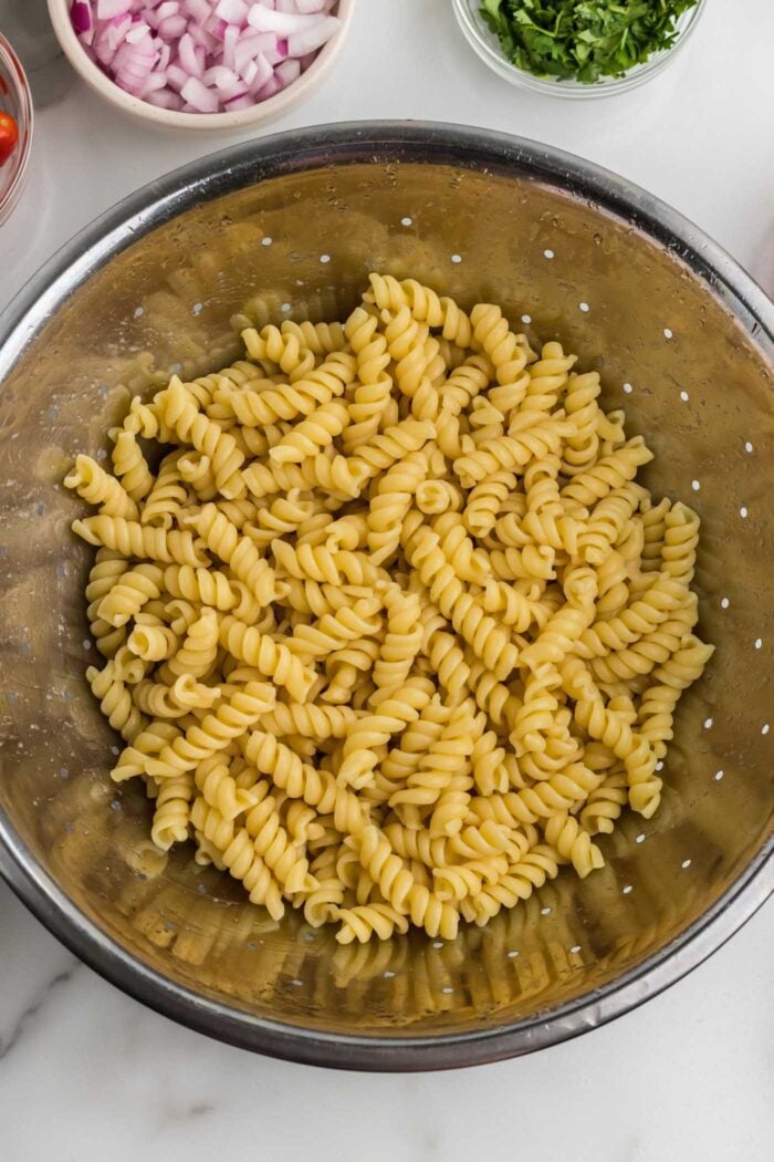 Cook rotini pasta in a colander.