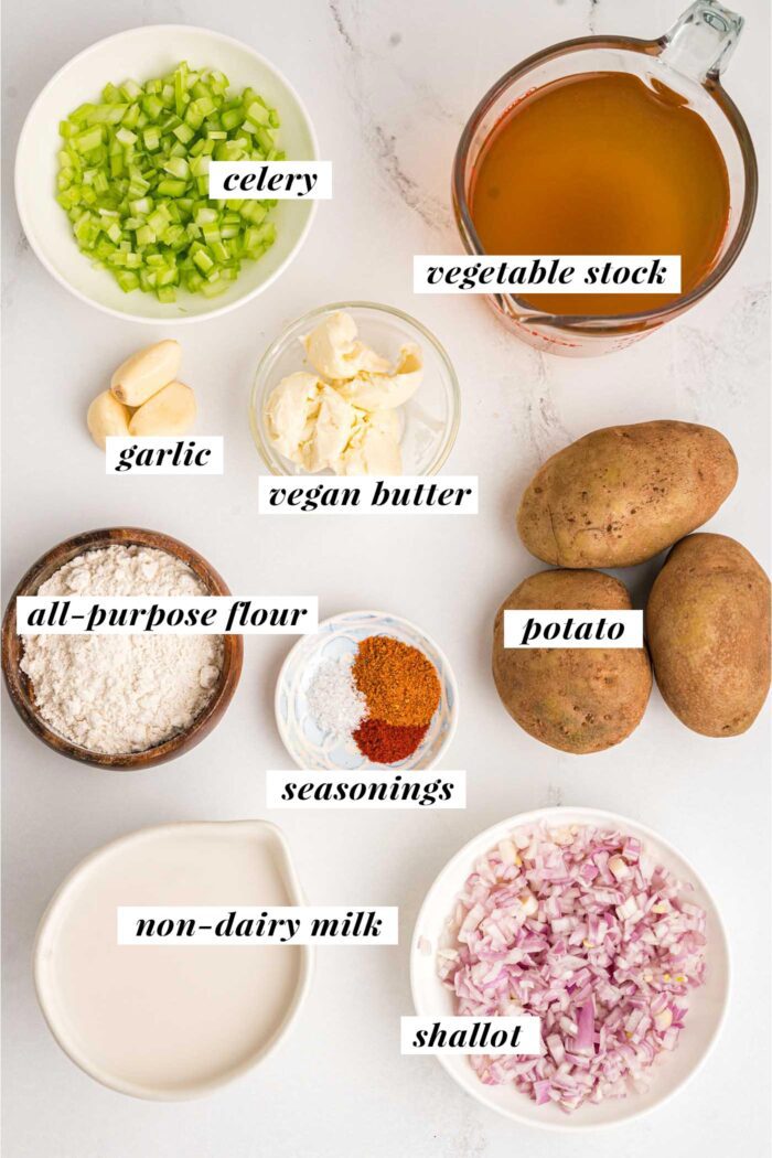 All of the ingredients gathered for making a vegan potato soup recipe. Each ingredient is labelled with text and the list can be found on the corresponding blog page.