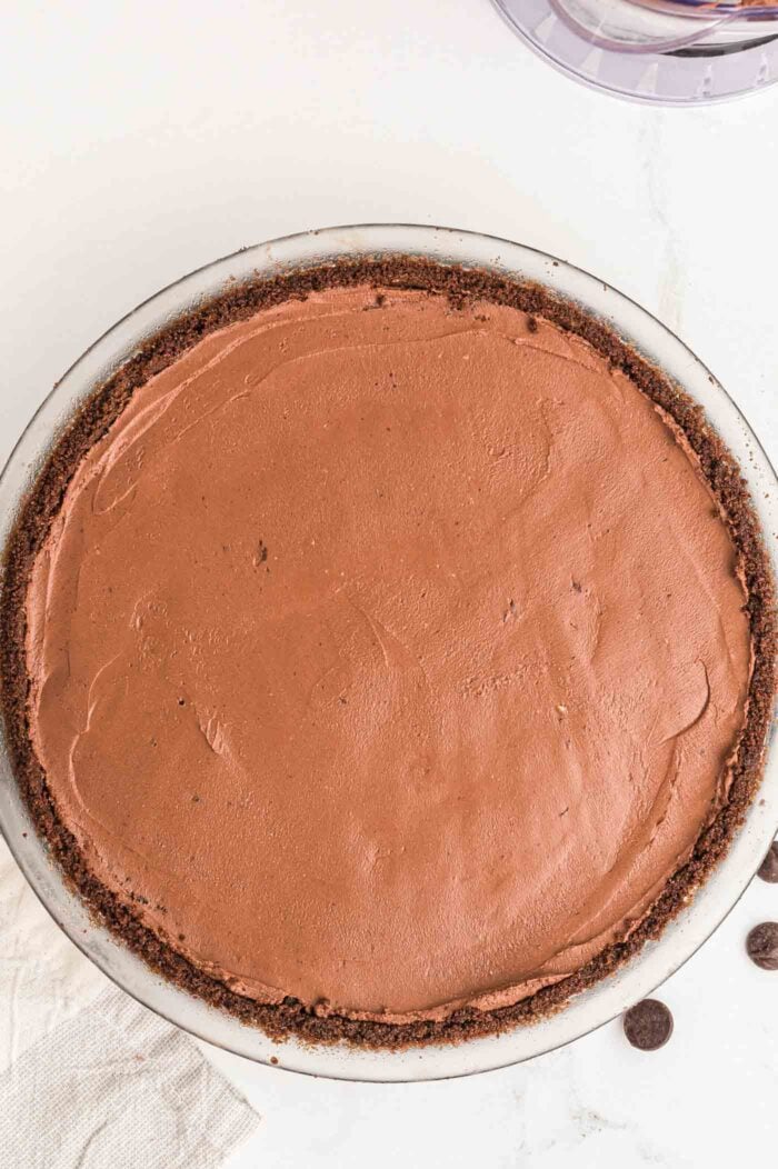 Overhead view of a chocolate pie with chocolate pie crust in a glass pie dish.