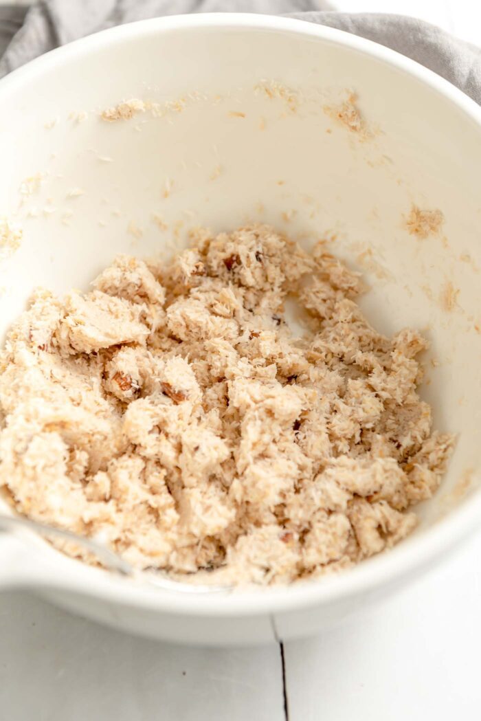 Crumbly coconut and almond macaroon cookie dough in a mixing bowl.
