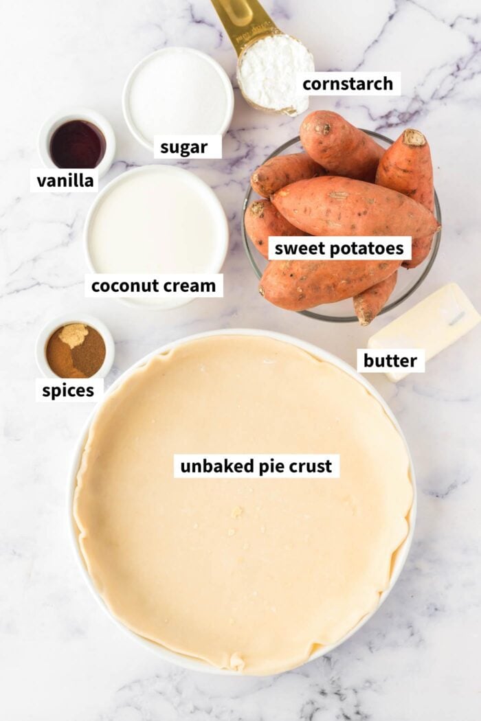 All of the ingredients for making a vegan sweet potato pie gathered up. Each ingredient is in a bowl and labelled with text describing the ingredient.