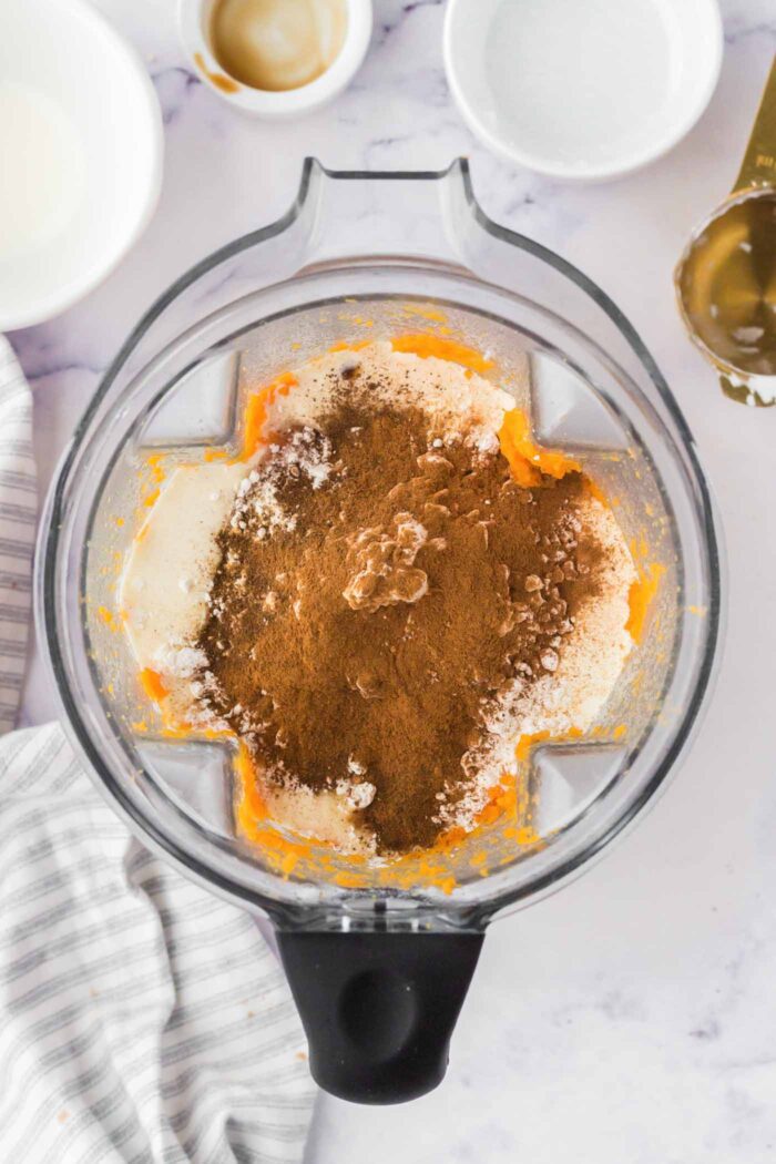 Coconut cream, spices and baked sweet potato in a Vitamix container.