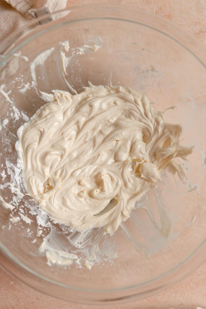 Butter and icing sugar beat together into a light and fluffy consistency in a mixing bowl.