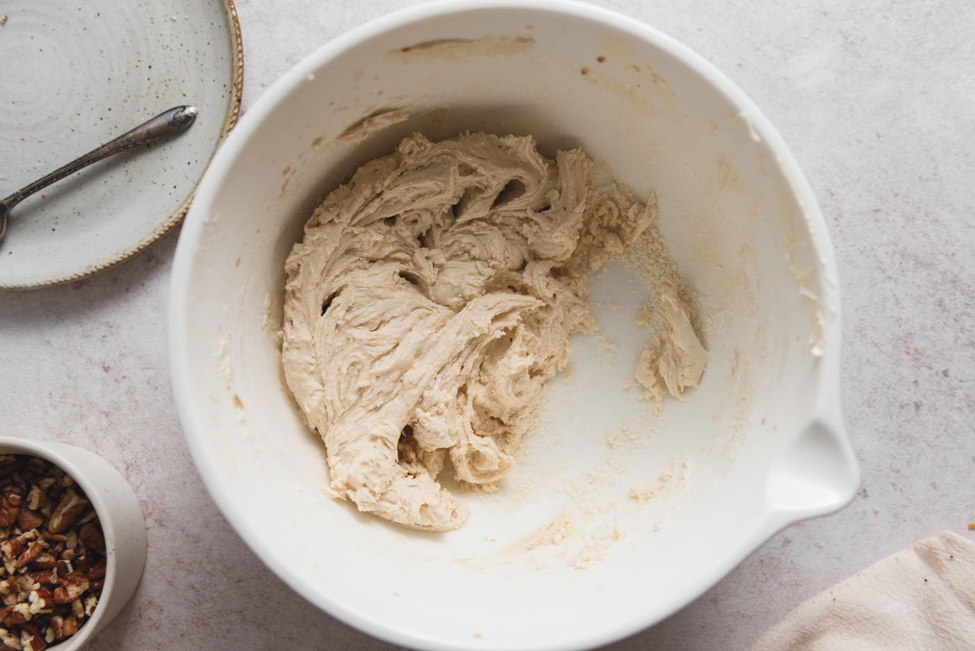 Flour, sugar and butter mixed into a dough in a mixing bowl.
