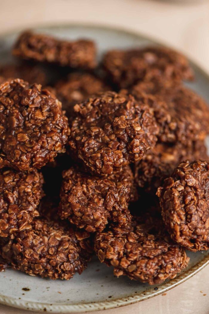 A close up of a plate of chocolate no-bake cookies made with oats.