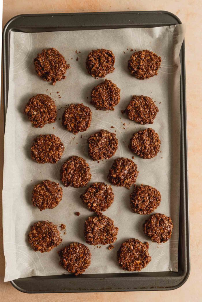 20 classic chocolate no-bake oatmeal cookies on a baking sheet.