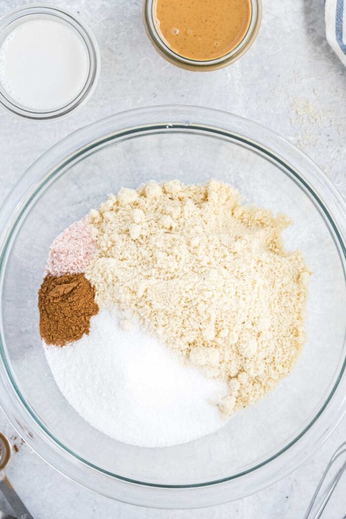 Almond flour, sugar, salt and and cinnamon in a glass mixing bowl.