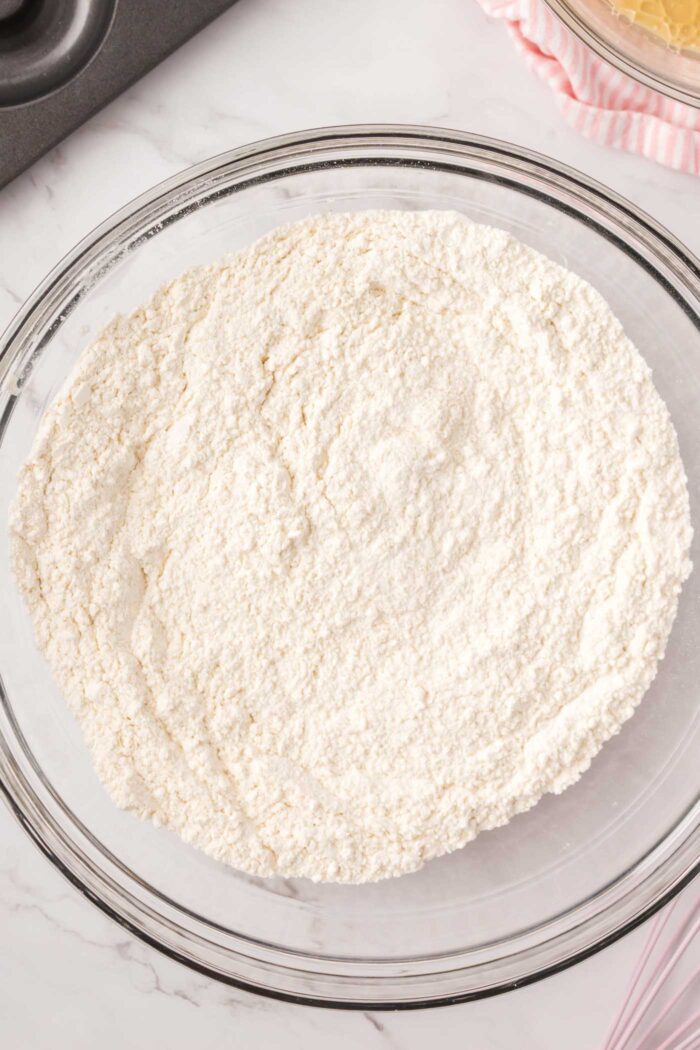 All-purpose flour in a large glass mixing bowl.