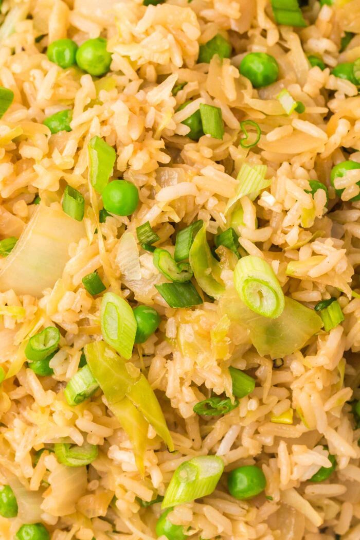 Close up of cabbage fried rice with peas and green onion.