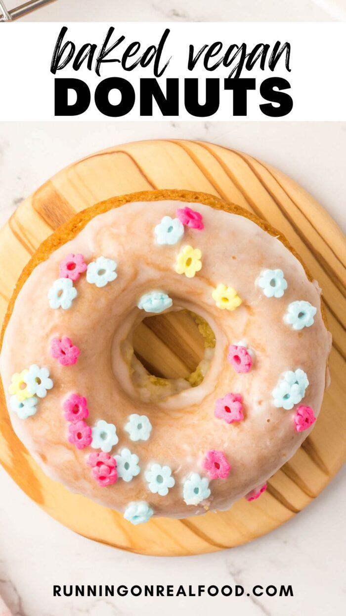 Pinterest graphic for a vegan baked donut recipe with an image of a glazed donut with sprinkles and a text stylized title.