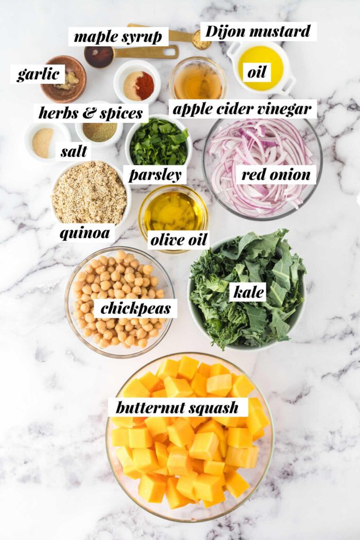 All the ingredients needed for a butternut squash quinoa salad recipe. Each ingredient is labelled with text.