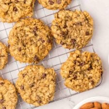 Overhead view of a number of almond flour oatmeal cookies on a baking cooling rack.