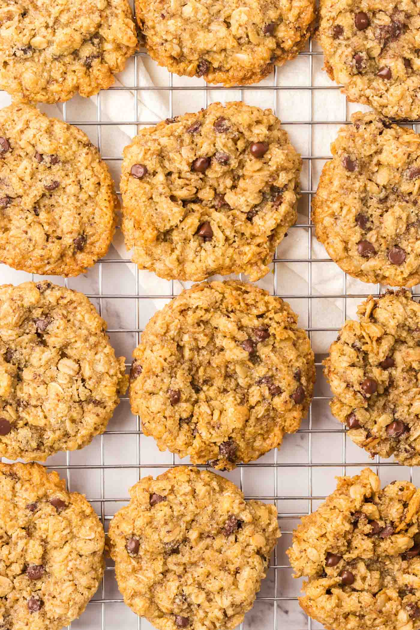 Overhead view of a number of almond flour oatmeal cookies on a baking cooling rack.