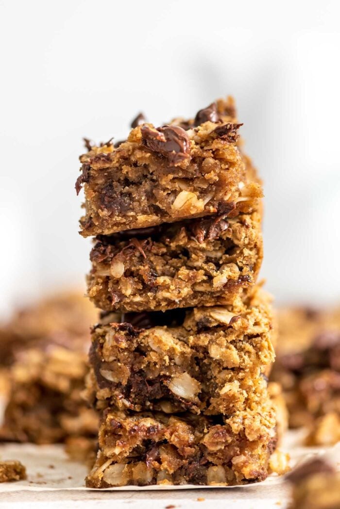 A stack of 4 peanut butter banana oatmeal bars with chocolate chips in them.