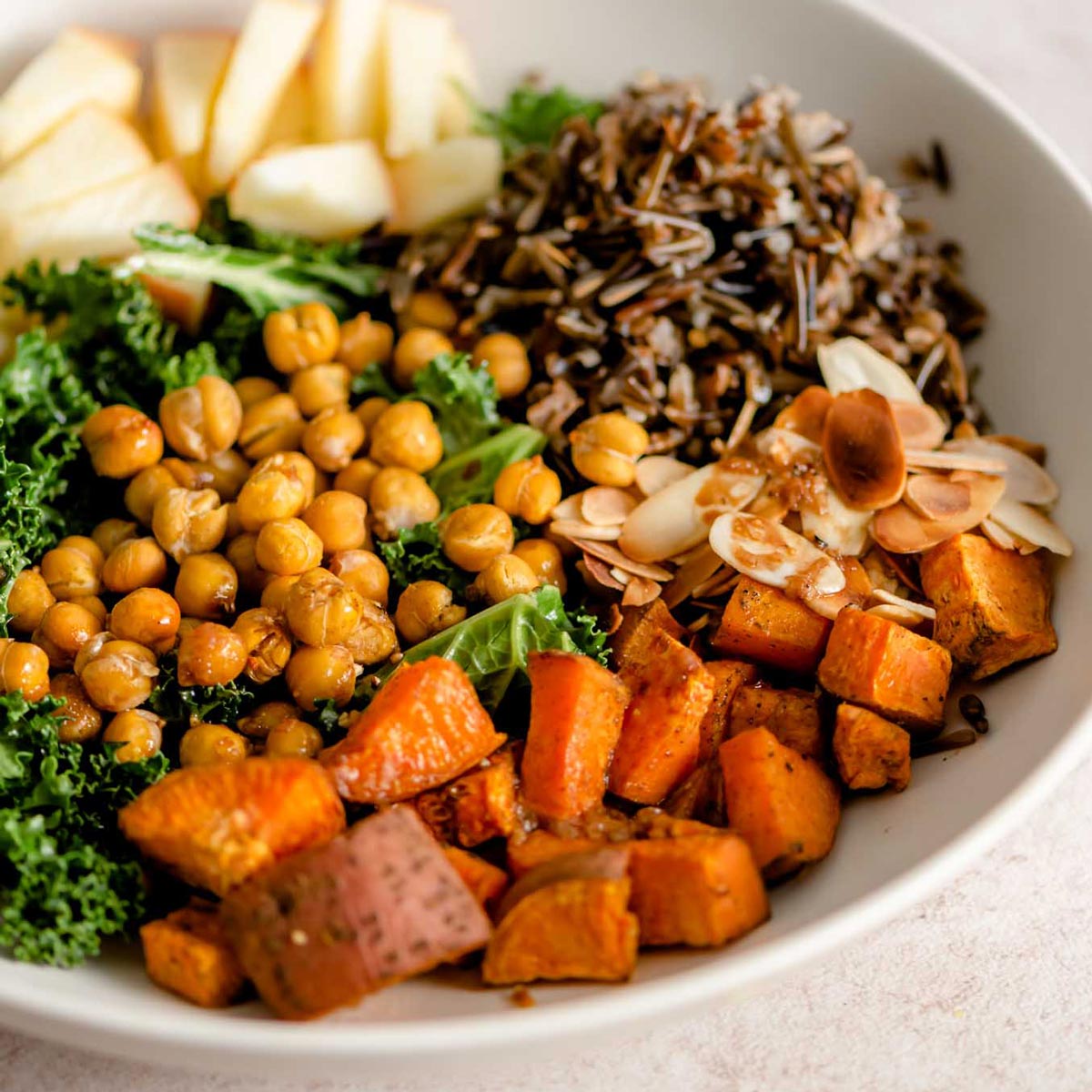 https://runningonrealfood.com/wp-content/uploads/2023/03/healthy-vegan-kale-sweet-potato-chickpea-harvest-bowl-recipe.jpg